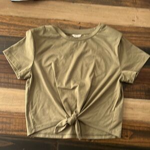 Green girls shirt with shoulder pads and a tie knot